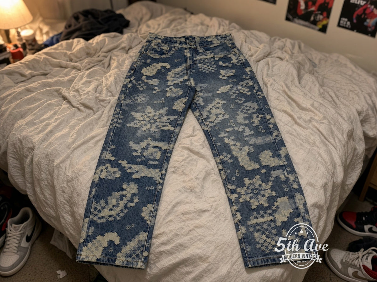 Pixel Floral Denim Jeans laid on bed