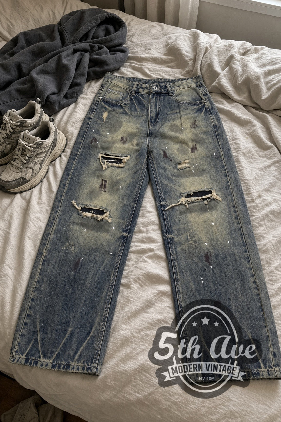 Dirty Wash Paint Splatter Zigzag Hem Jeans – Vintage Streetwear vintage jeans laid on bed