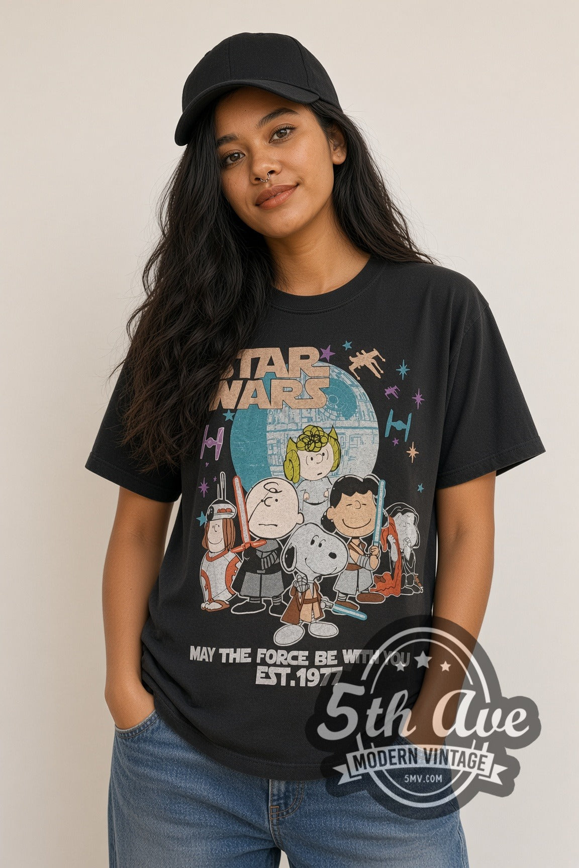 Woman wearing faded black Peanuts x Star Wars May the Force Be With You Est. 1977 vintage cartoon tee