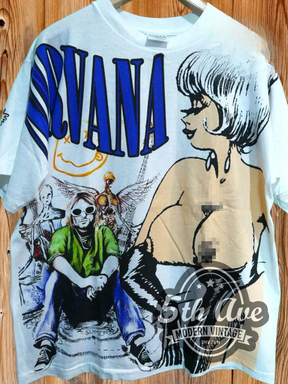 Nirvana Collage vintage band t-shirt, front view on a display rack