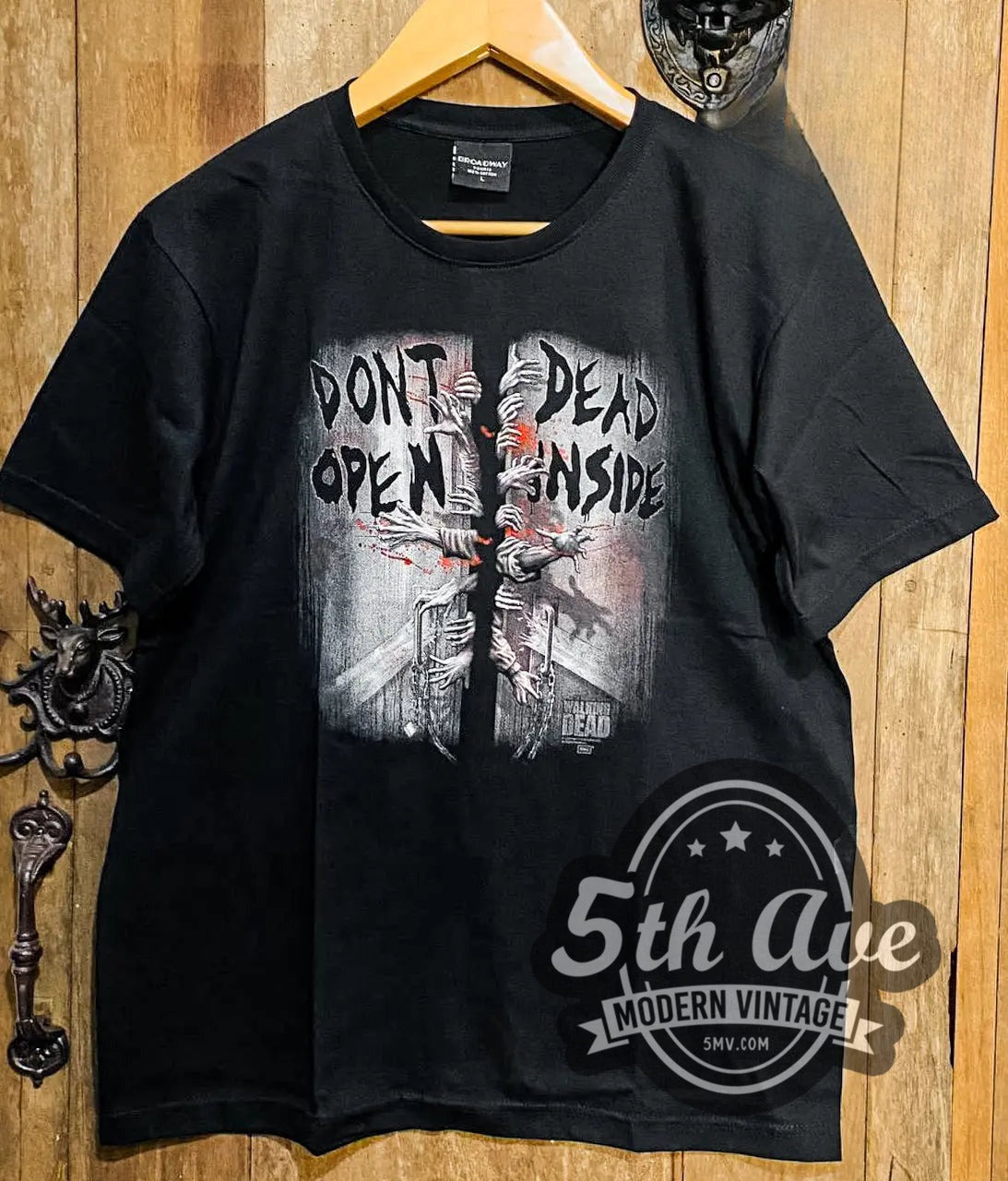 The Walking Dead Don't Open Dead Inside vintage movie t-shirt, front view on a display rack