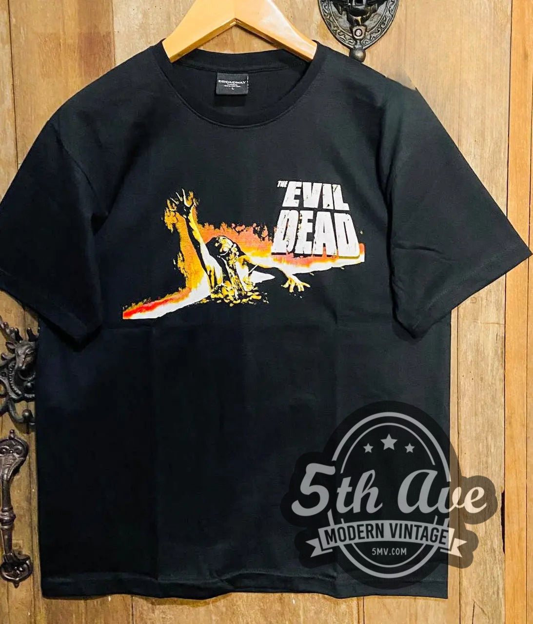 The Evil Dead vintage movie t-shirt, front view on a display rack