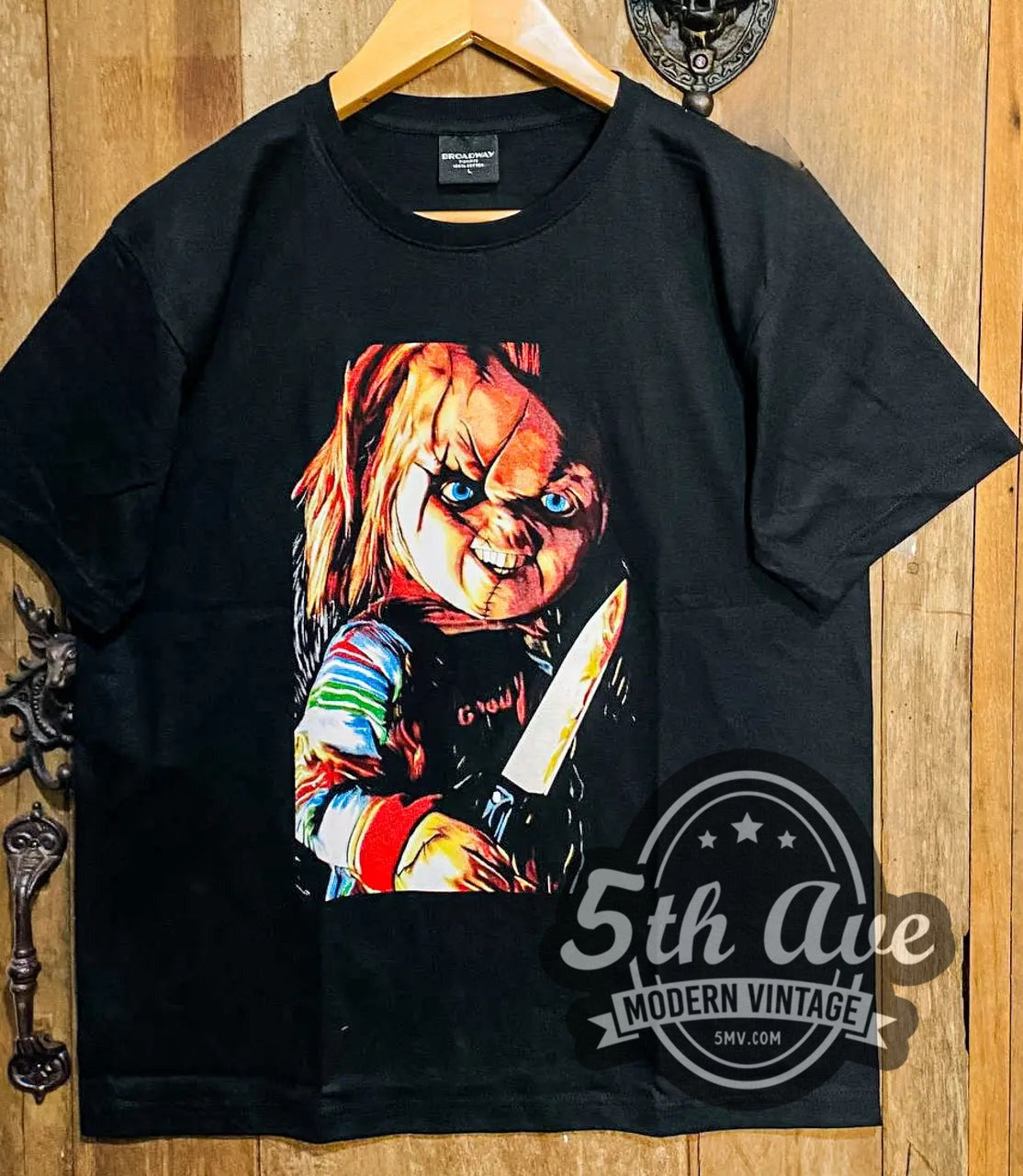 Child's Play Chucky with Knife vintage movie t-shirt, front view on a display rack