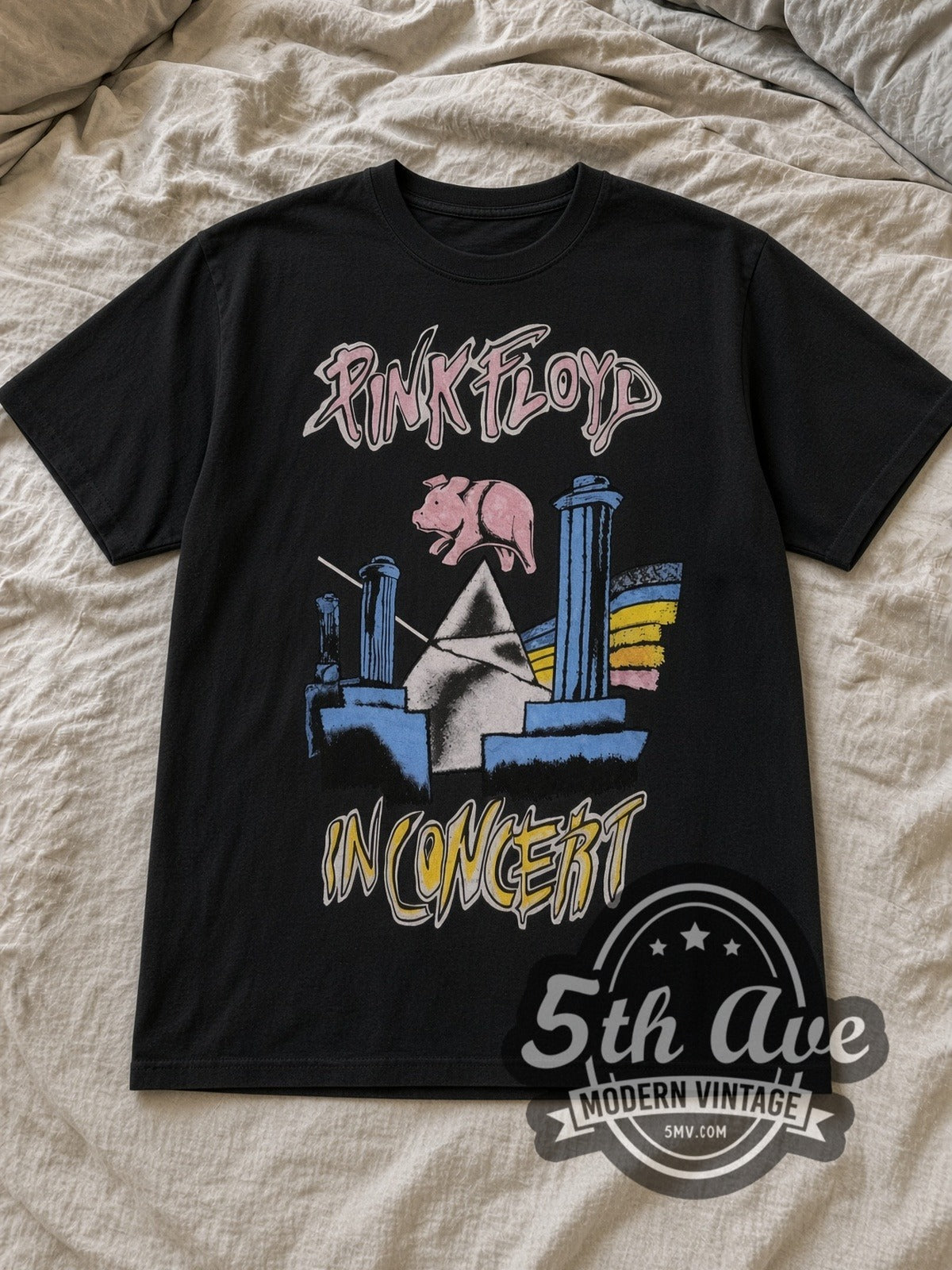 Black Pink Floyd 1977 Tour Vintage Band T-Shirt laid flat on a linen bed