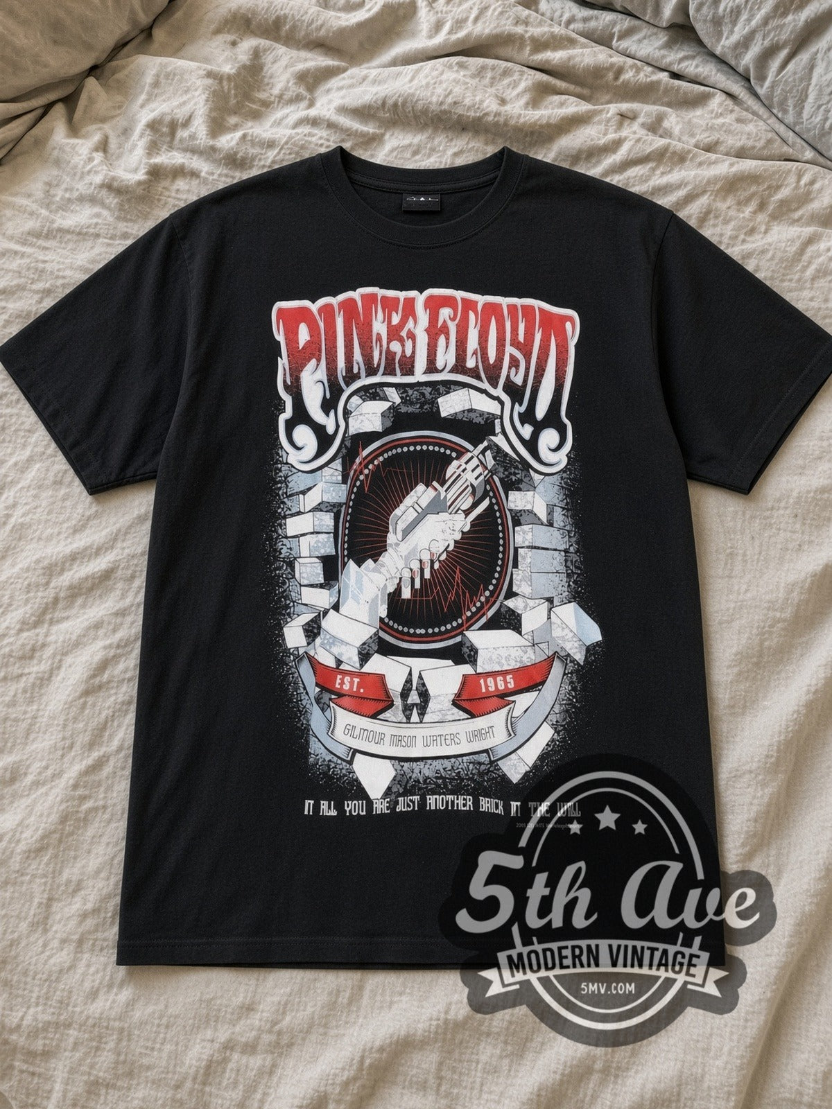 Black Pink Floyd Another Brick In the Wall Vintage Band T-Shirt laid flat on a linen bed