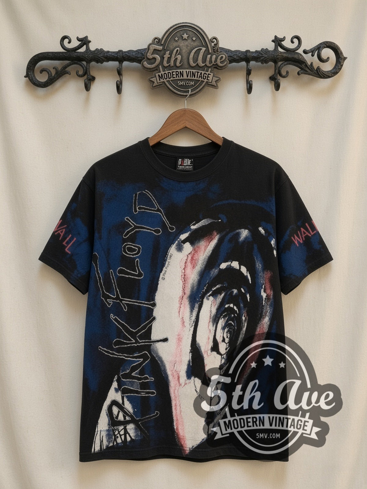 Pink Floyd The Wall Scream all-over-print vintage band t-shirt in black, front view on a display rack