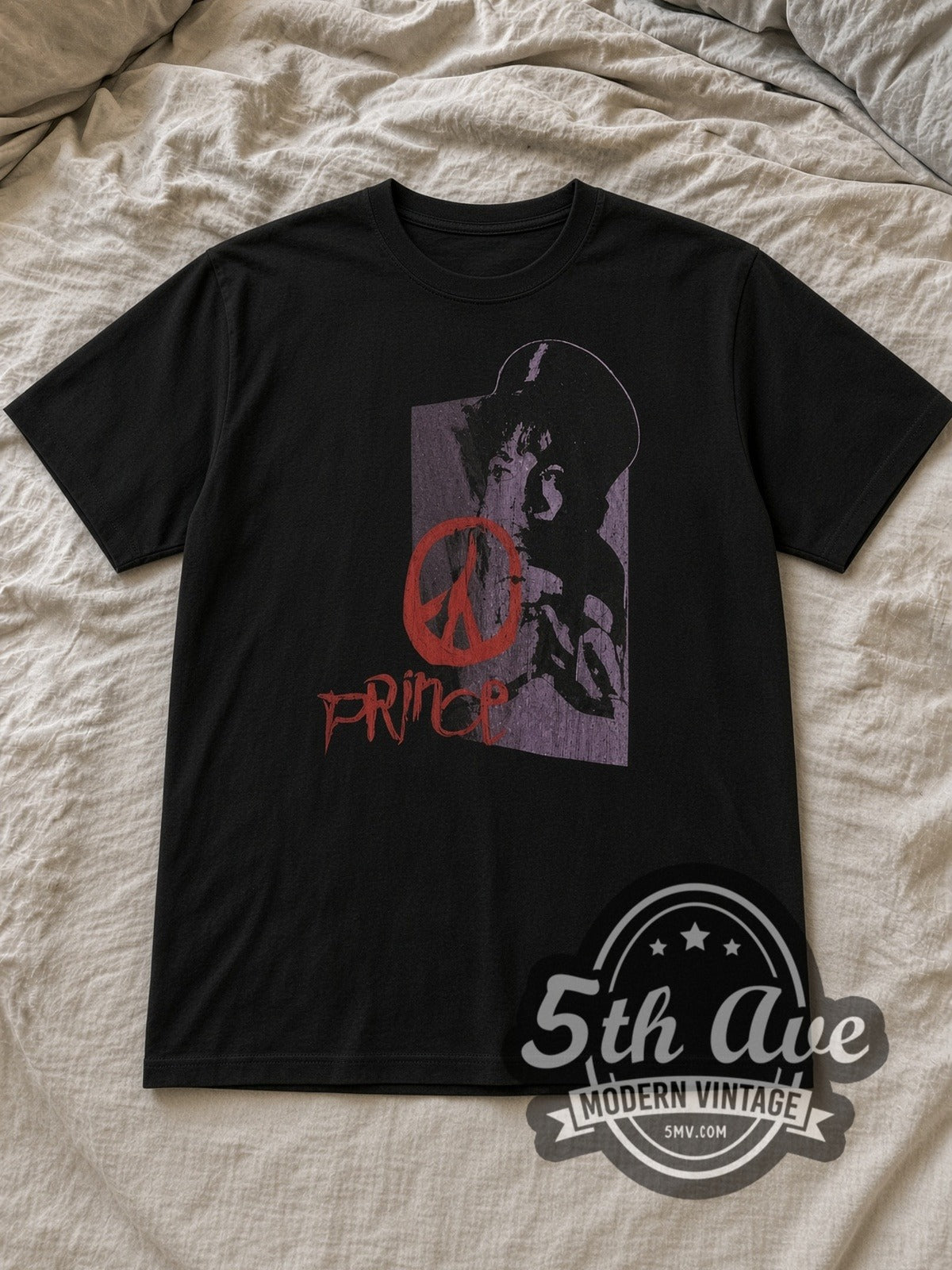 Black Prince Purple Portrait Red Peace Sign Vintage Band T-Shirt laid flat on a linen bed