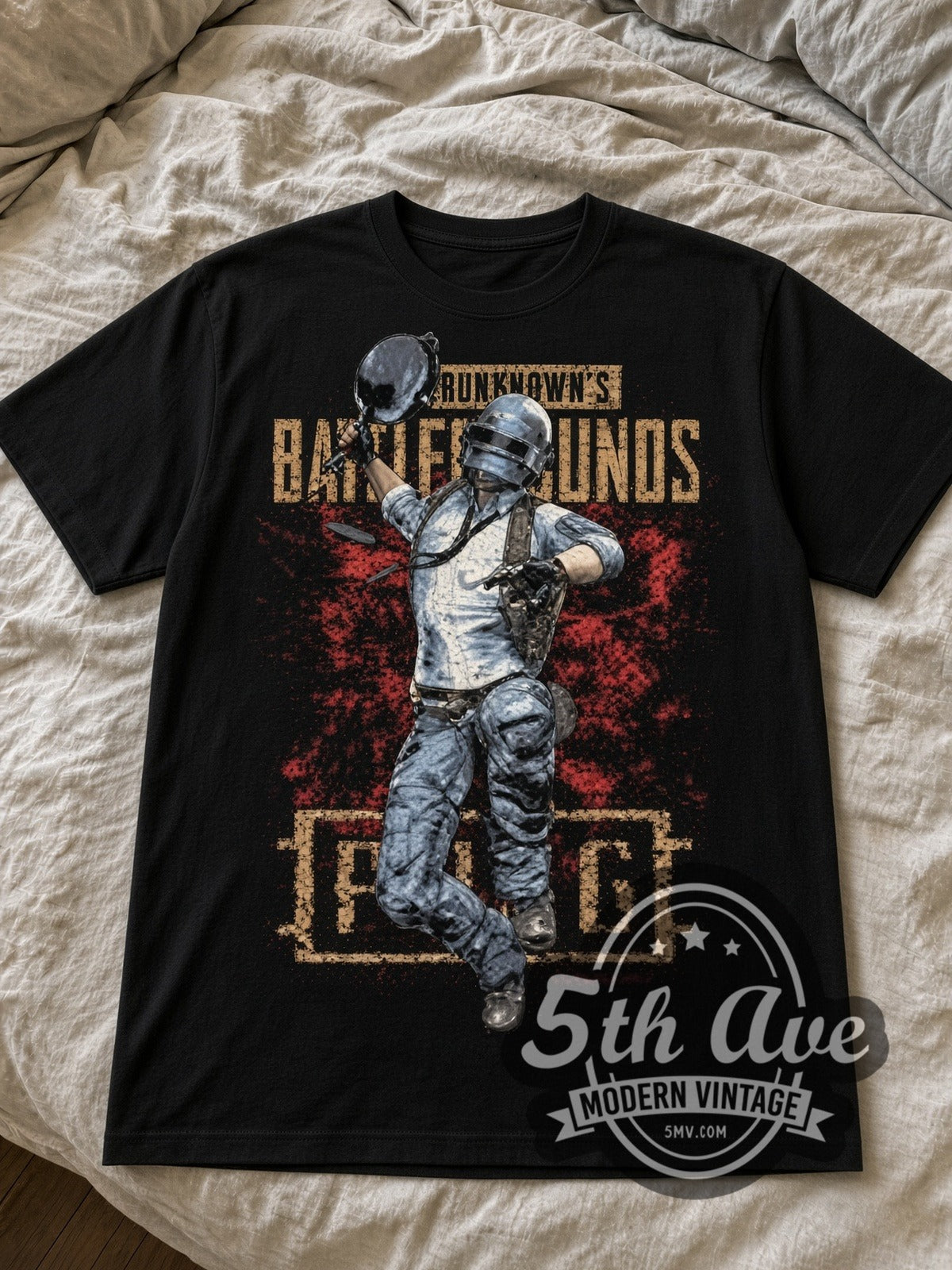 PUBG Helmeted Player black graphic tee laid flat on linen bed
