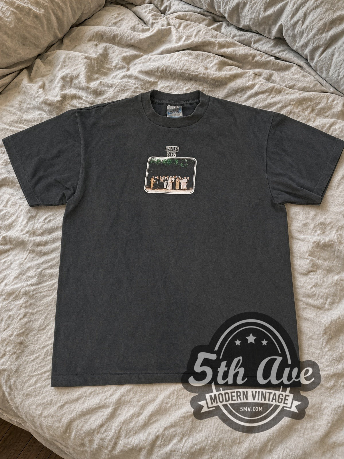 Faded black Pulp Common People UK tour tee laid flat on linen bed