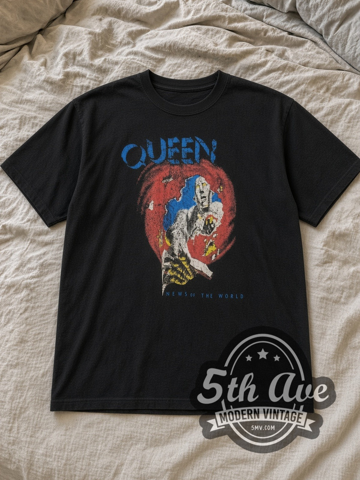 Black Queen News of the World Vintage Band T-Shirt laid flat on a linen bed