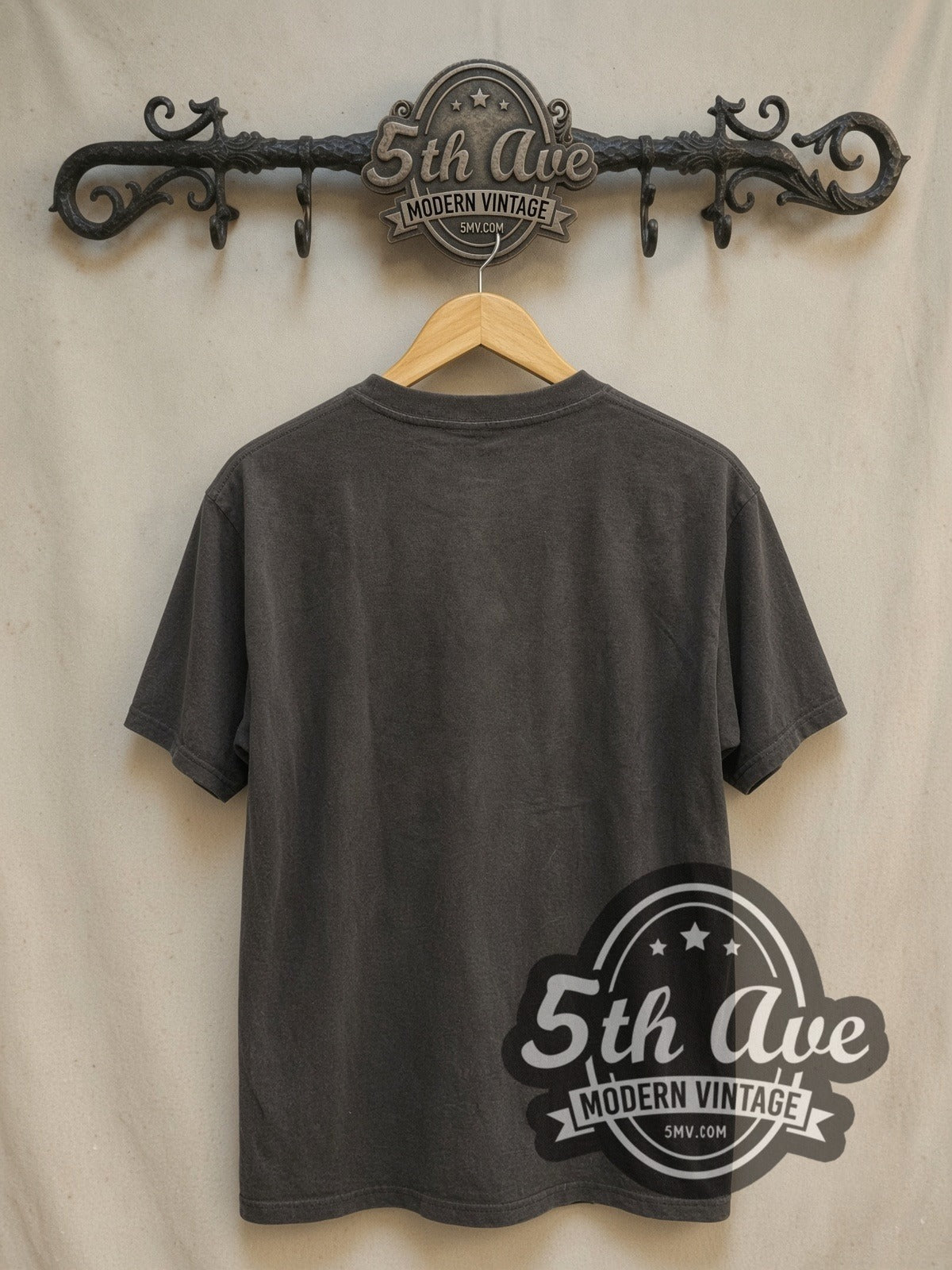 Discharge Tributo vintage band t-shirt, back view on a display rack