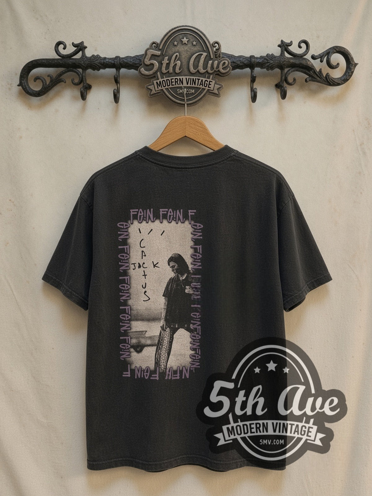 Travis Scott × Stüssy FEIN / Cactus Jack vintage band t-shirt, back view on a display rack