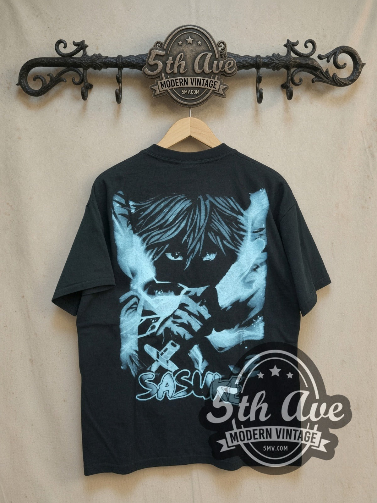 Naruto Shippuden Sasuke Uchiha vintage graphic t-shirt, back view on a display rack