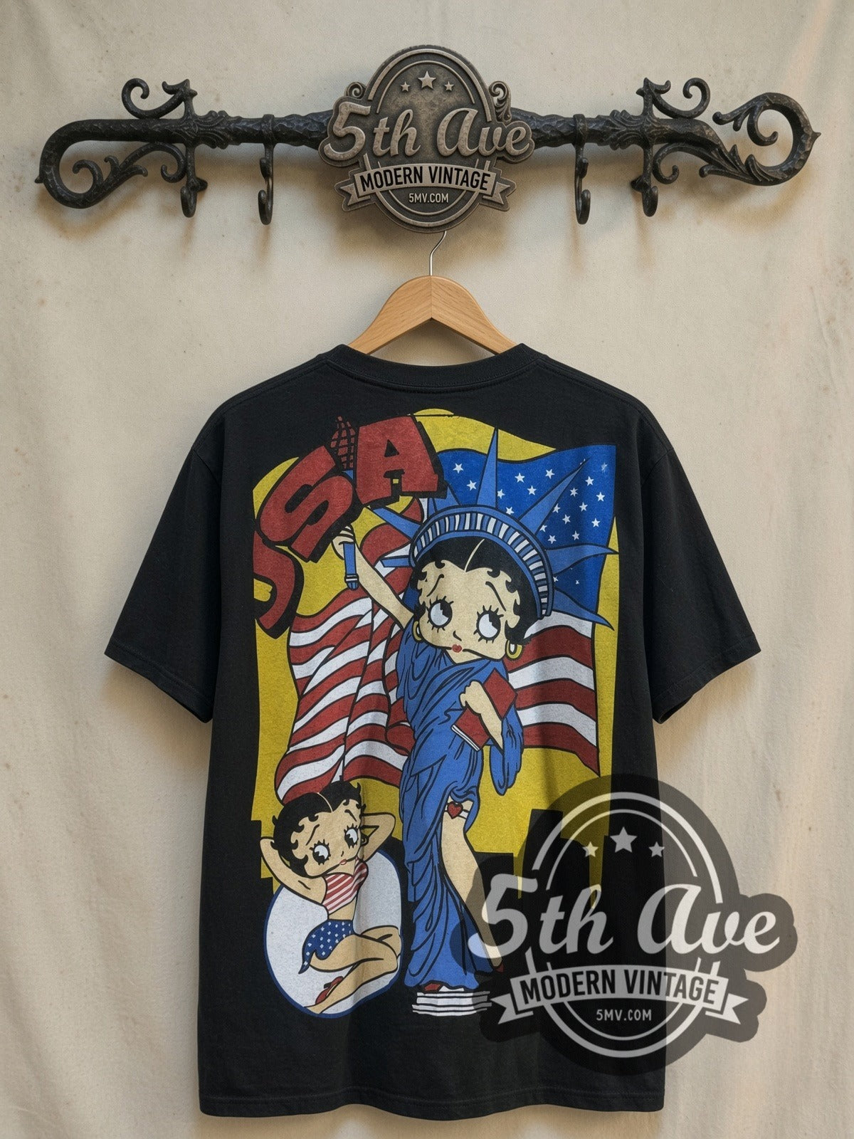 Betty Boop USA Graphic all-over-print vintage cartoon tee, back view on a display rack
