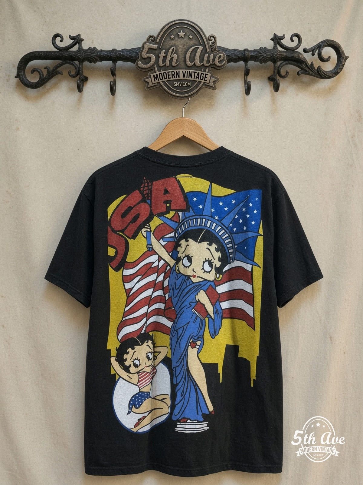 Betty Boop – USA Graphic – All Over Print – New Vintage Graphic Tee — back on locked cream ornate 5th Ave rack