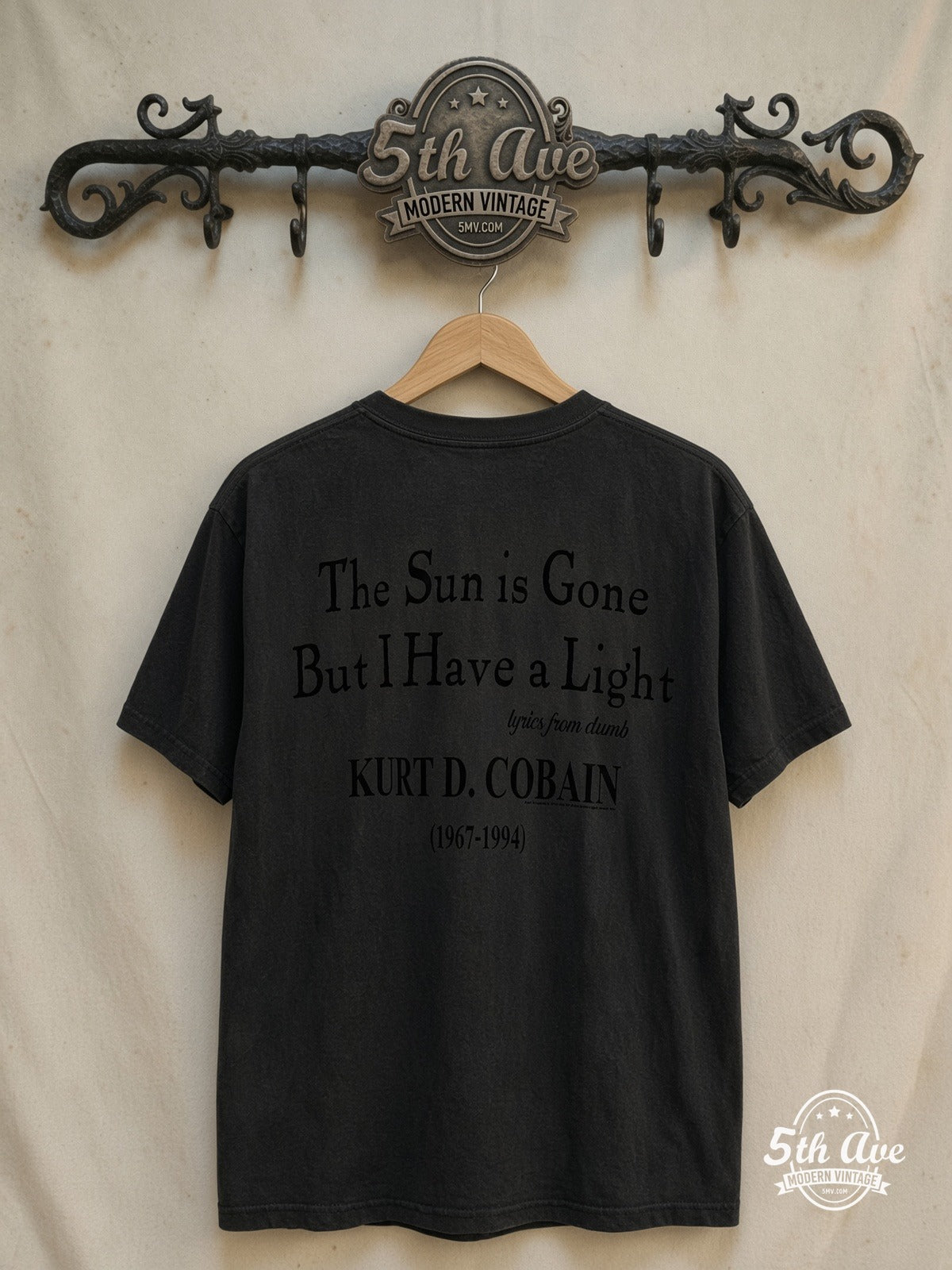 Nirvana – Kurt Cobain Playing Guitar – Vintage Band T-Shirt — back on locked cream ornate 5th Ave rack