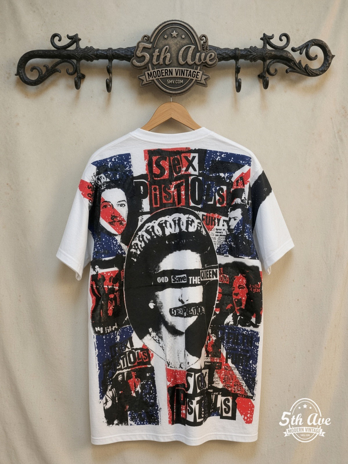 Sex Pistols – God Save the Queen – All Over Print – Vintage Band T-Shirt — back on locked cream ornate 5th Ave rack