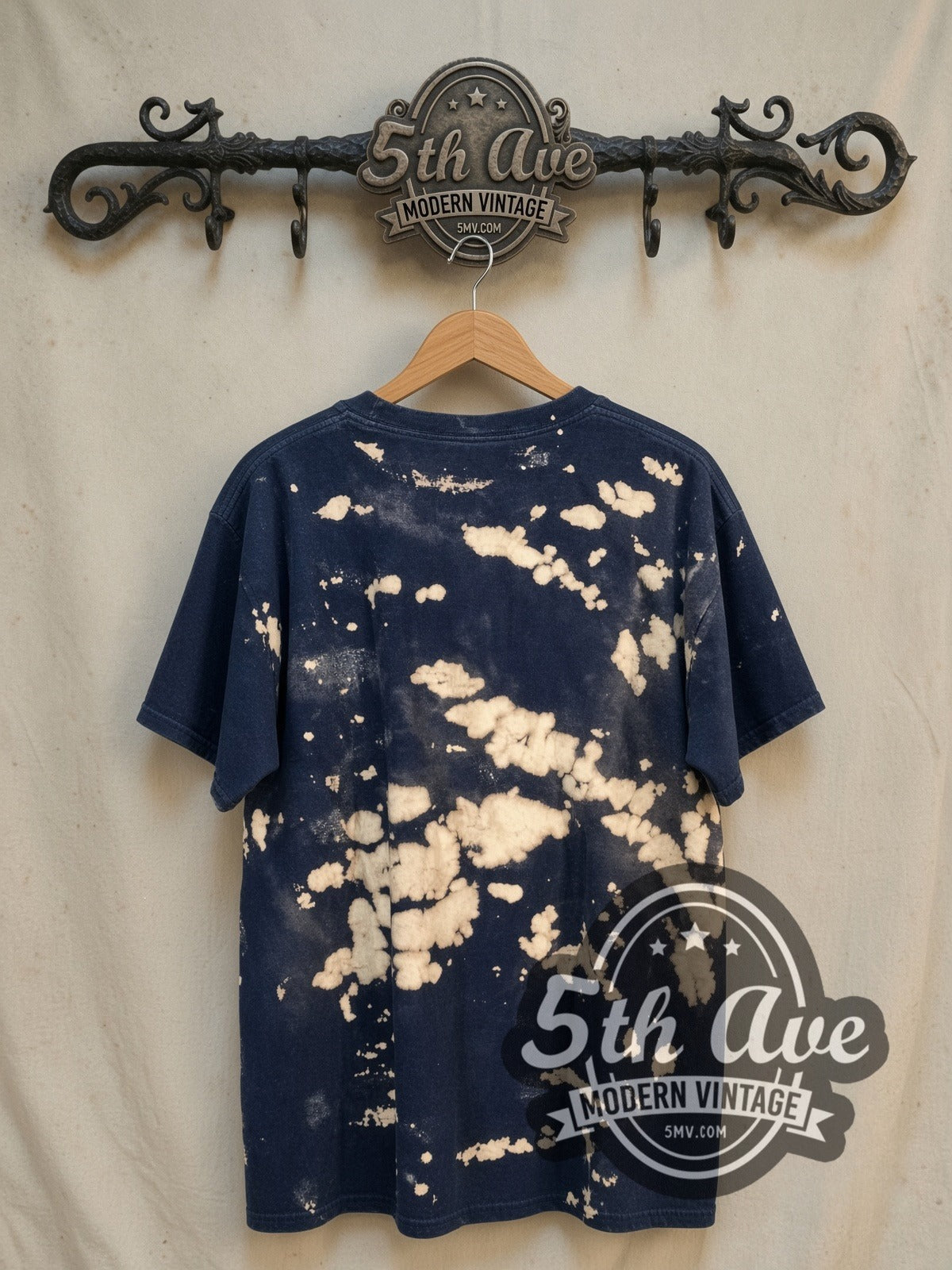 Elvis Presley King of Rock and Roll all-over-print vintage band t-shirt, back view on a display rack
