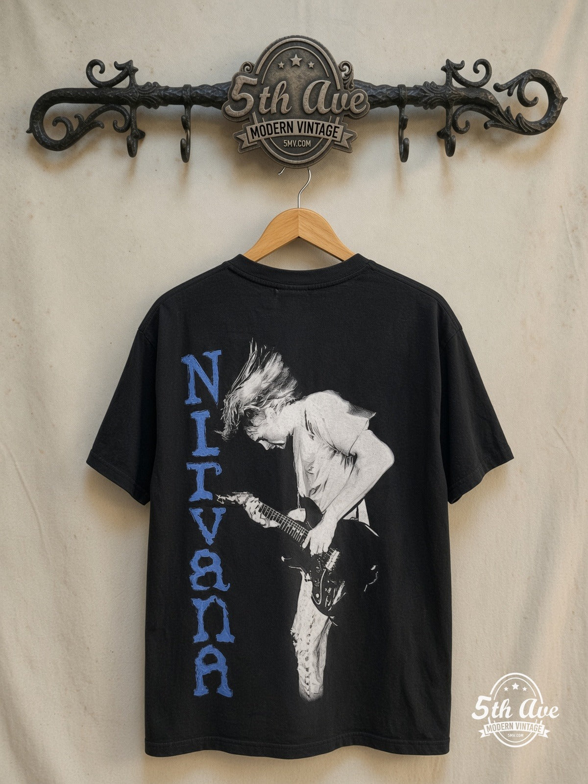 Nirvana – Kurt Cobain Blue Logo Play Electric Guitar – Vintage Band T-Shirt — back on locked cream ornate 5th Ave rack
