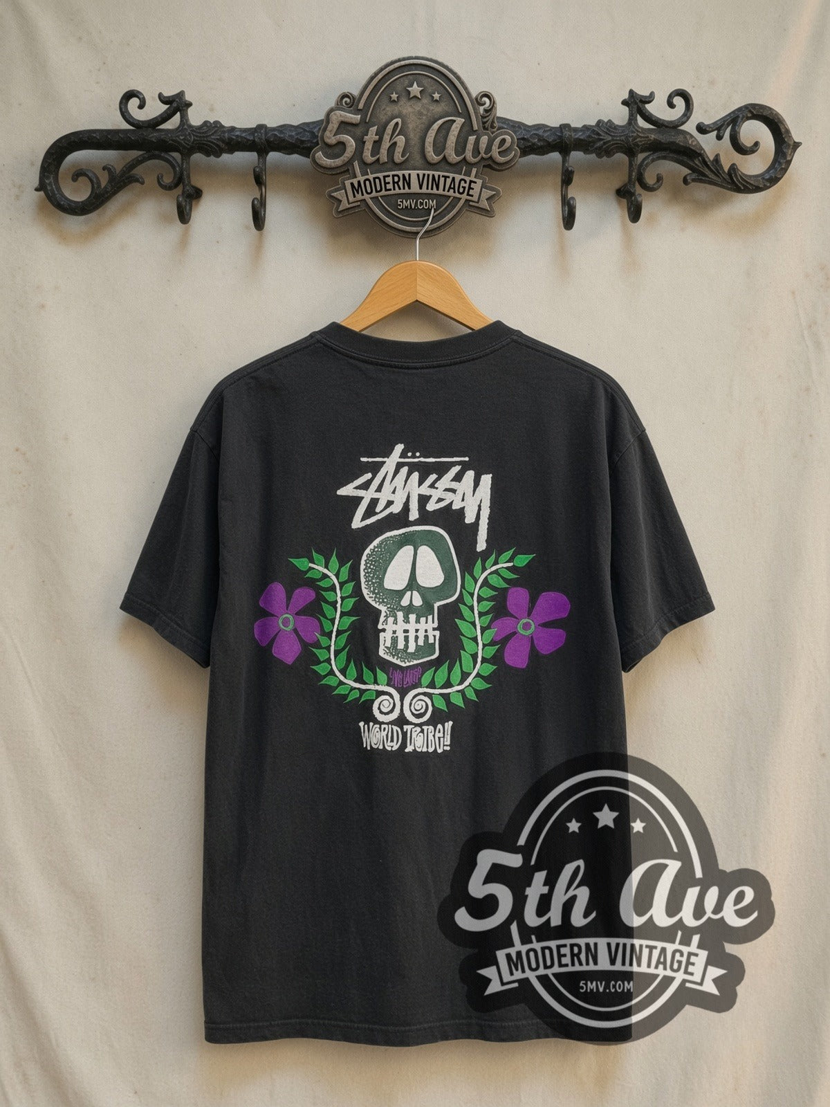 Stussy World Tribe Skull Crest vintage graphic tee in black, back view on the 5MV rack