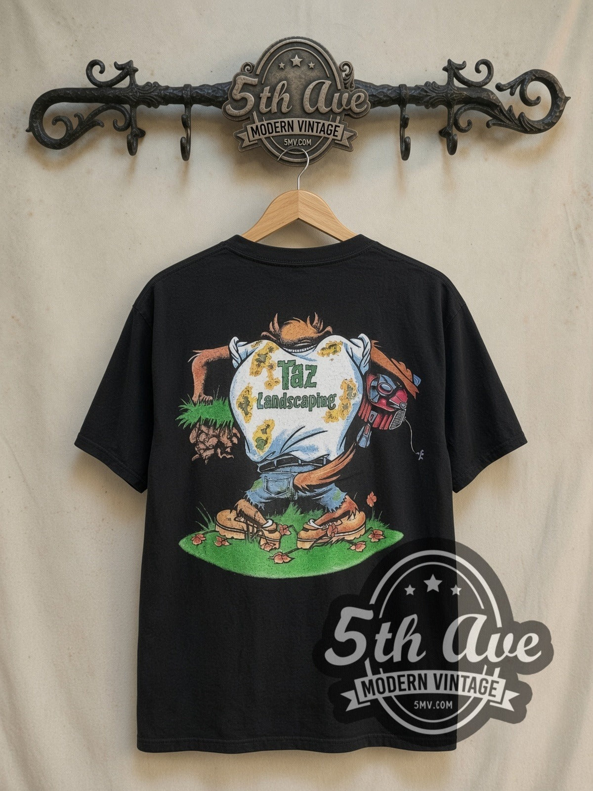 Looney Tunes Taz-Mania Landscaping vintage cartoon tee in black, back view on a display rack