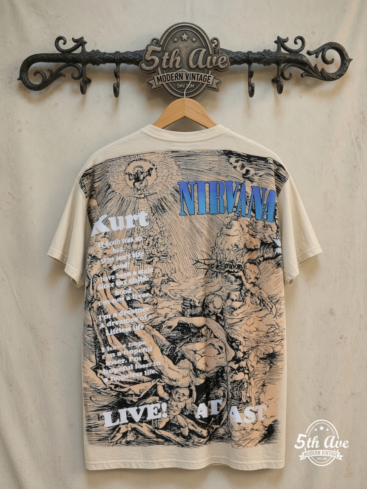 Nirvana – Live at Last – Vintage Band T-Shirt — back on locked cream ornate 5th Ave rack