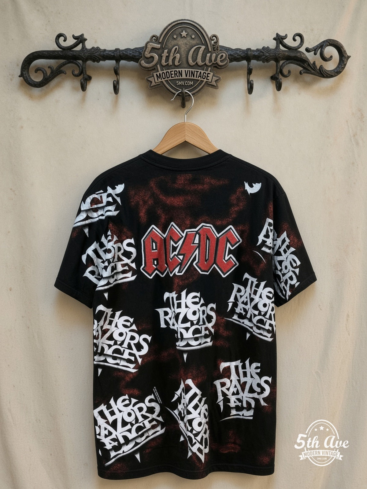 AC/DC – Electrifying Energy: The AC/DC "Razor's Edge" All-Over Print t shirt i – Vintage Band T-Shirt — back on locked cream ornate 5th Ave rack
