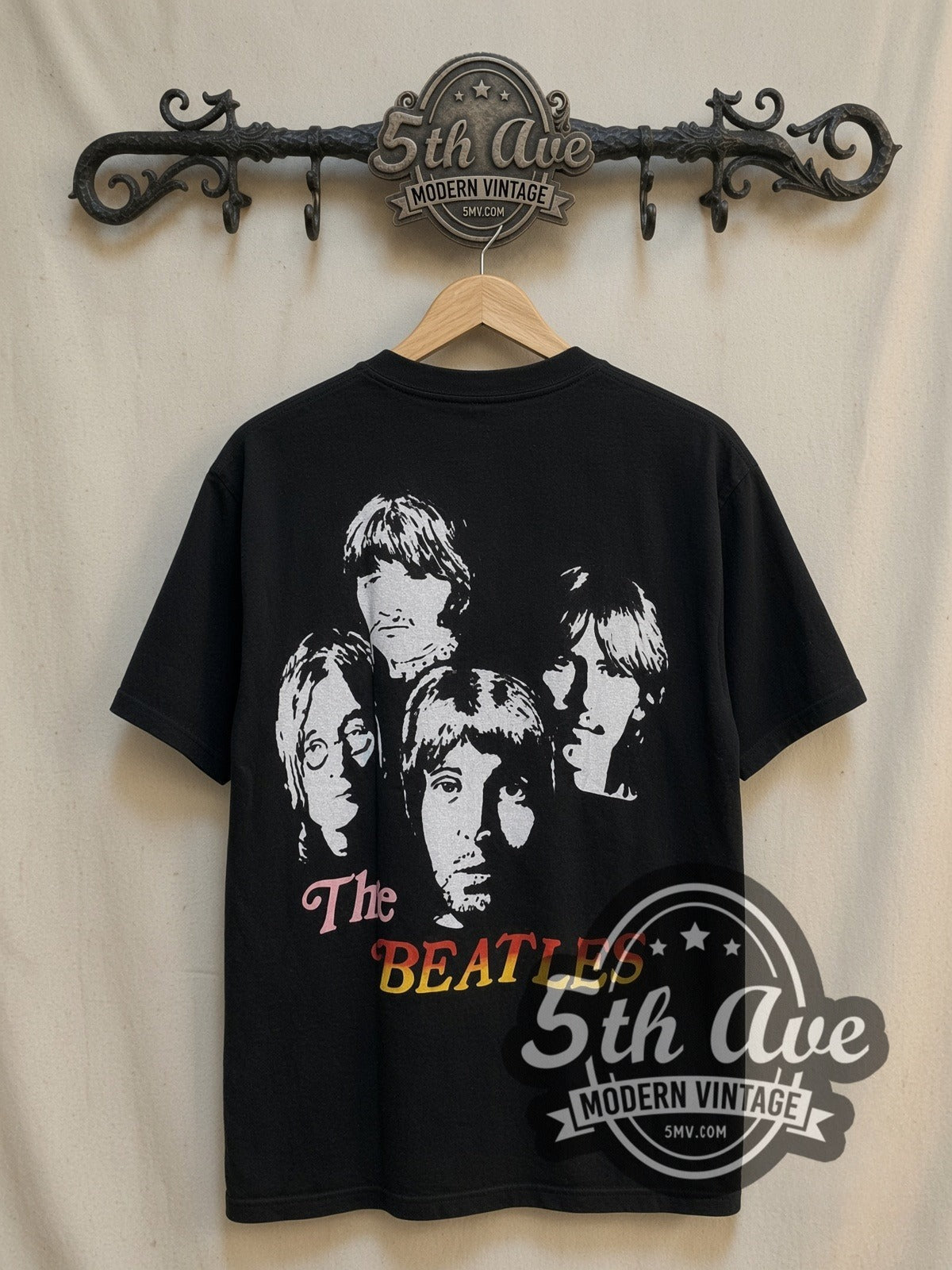 The Beatles Union Jack Red Logo Mop-Top vintage band t-shirt, back view on a display rack
