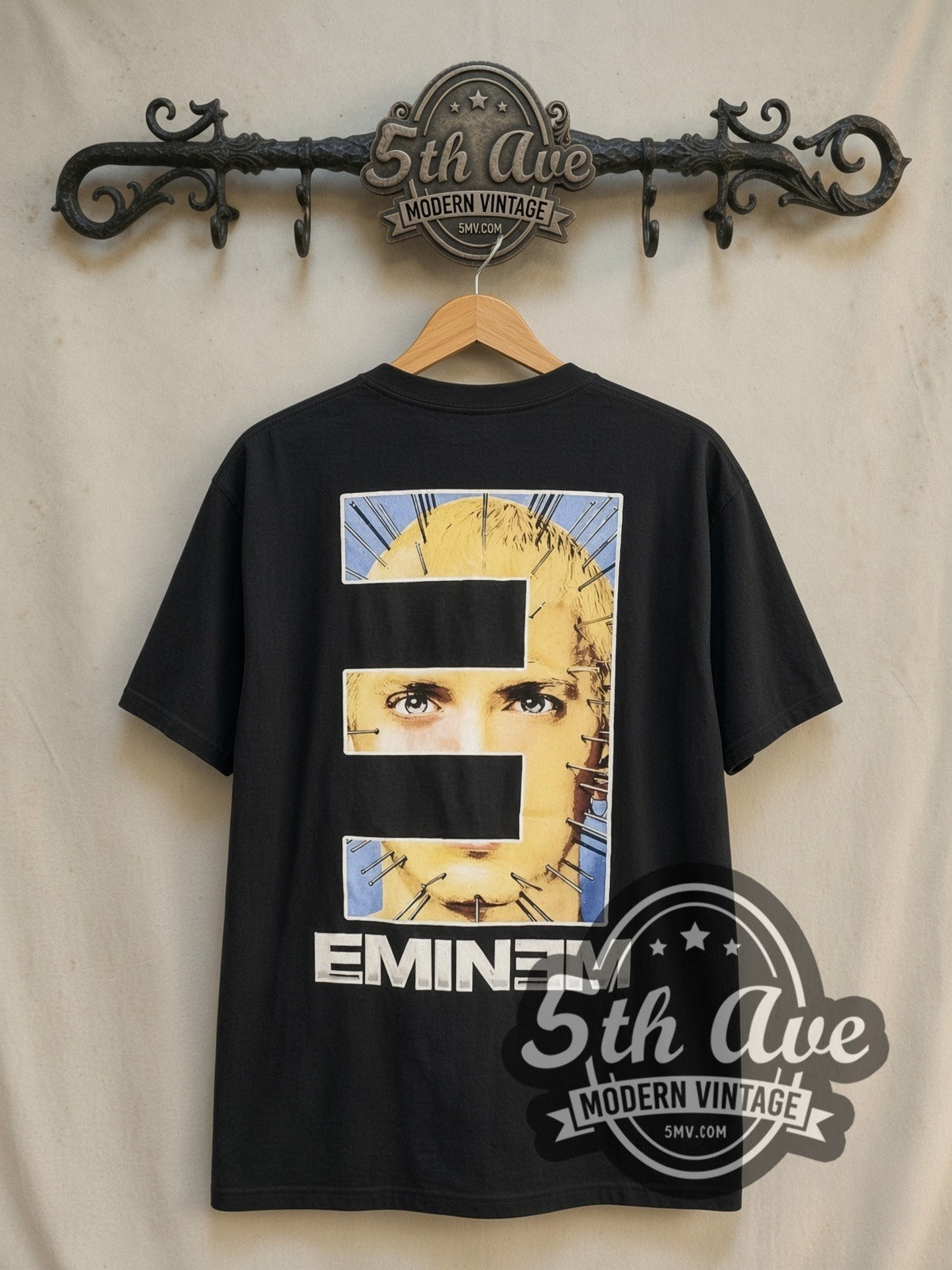 Eminem Pinhead "EMINƎM vintage band t-shirt in black, back view on a display rack