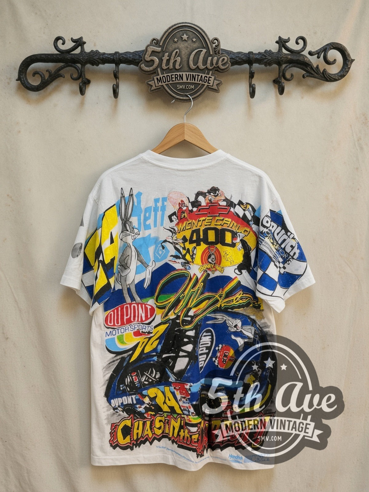 NASCAR Bugs Bunny and Jeff Gordon all-over-print vintage graphic t-shirt, back view on a display rack