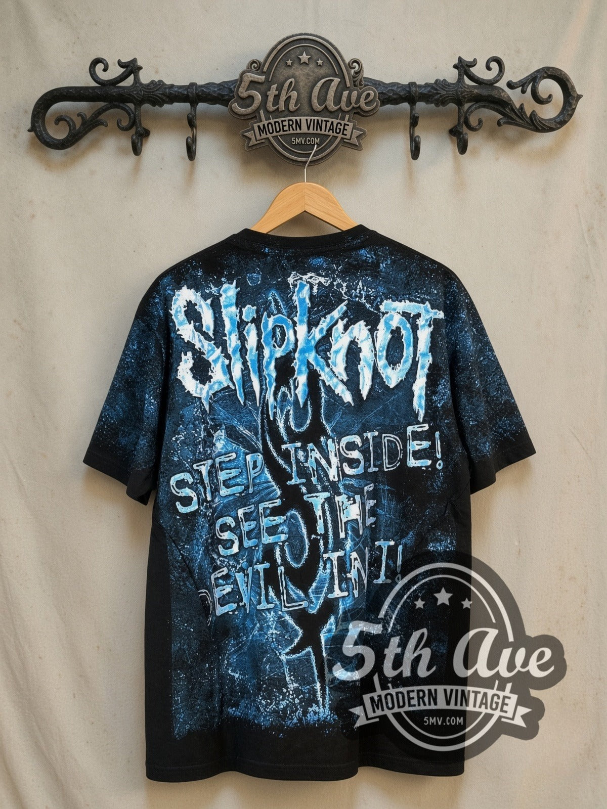 Slipknot The Devil in I all-over-print vintage band t-shirt, back view on a display rack