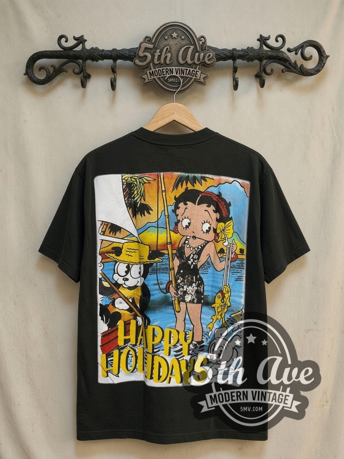 Betty Boop Happy Holidays all-over-print vintage cartoon tee, back view on a display rack