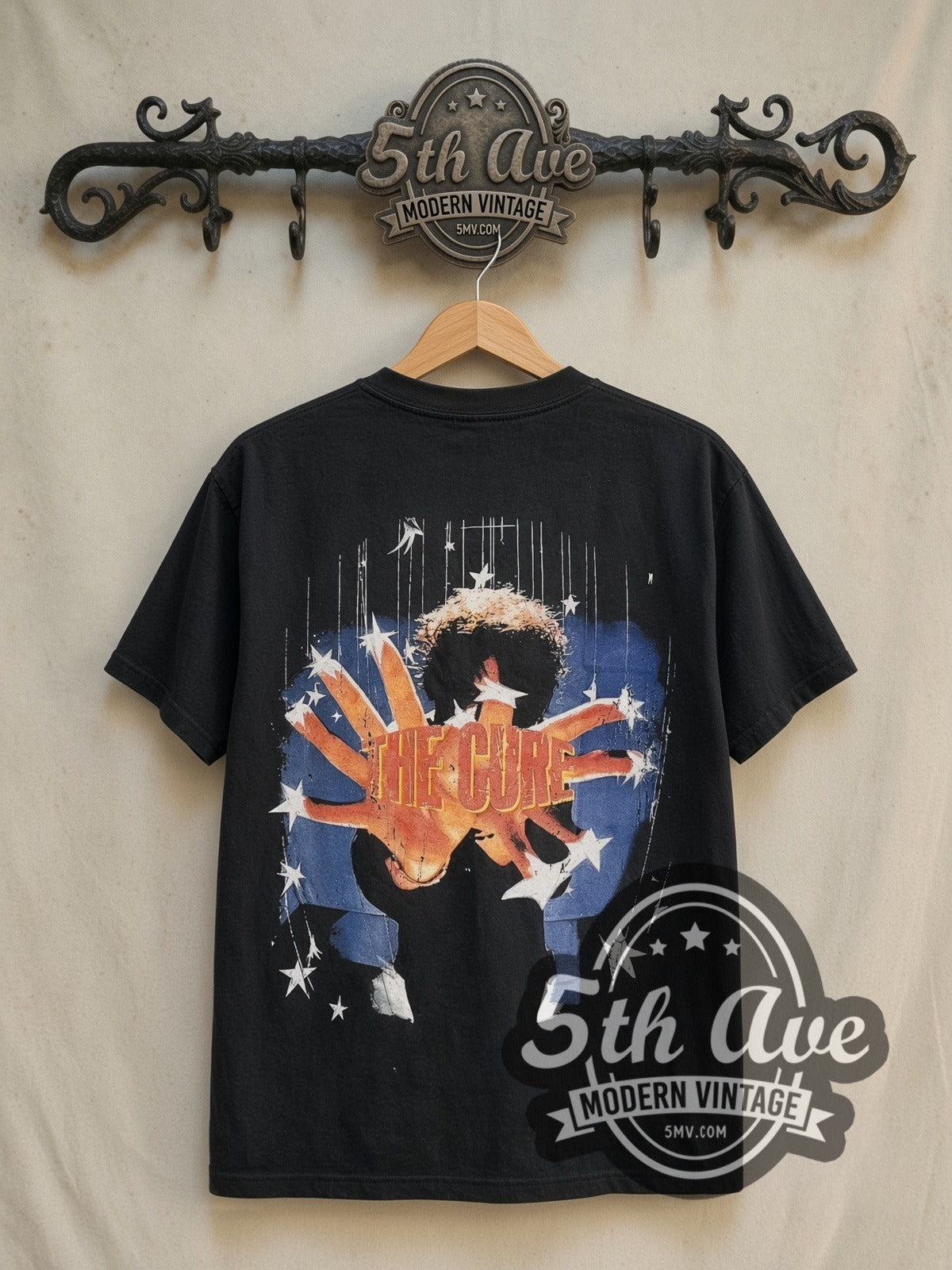 The Cure Greatest Hits vintage band t-shirt in black, back view on a display rack