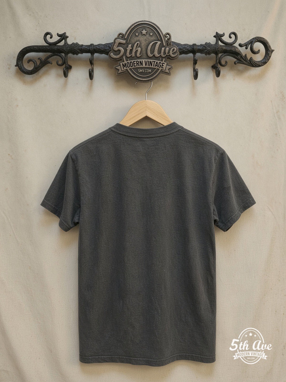 Rock 'n' Roll Elegance: Guns N' Roses Circular Logo T-Shirt – Vintage Band T-Shirt — back on locked cream ornate 5th Ave rack