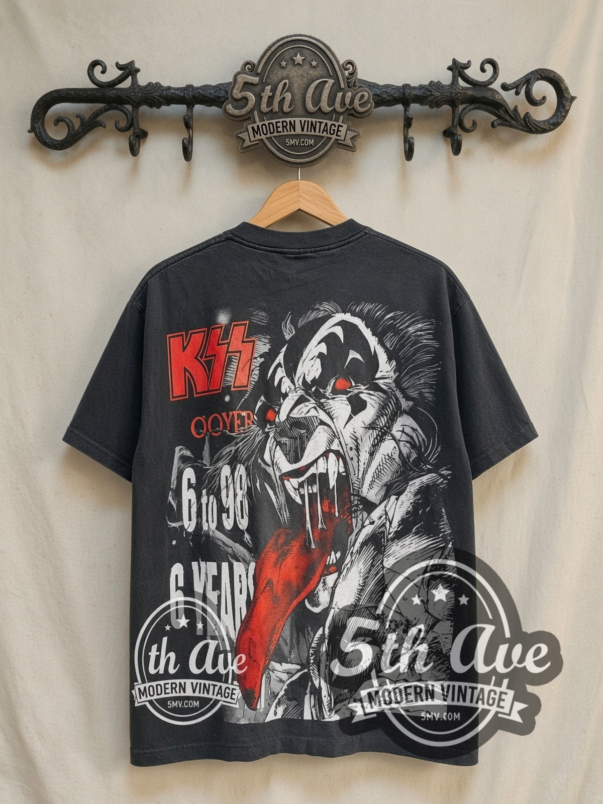 KISS Destroyer 22 Years of Destruction all-over-print vintage band t-shirt in black, back view on a display rack