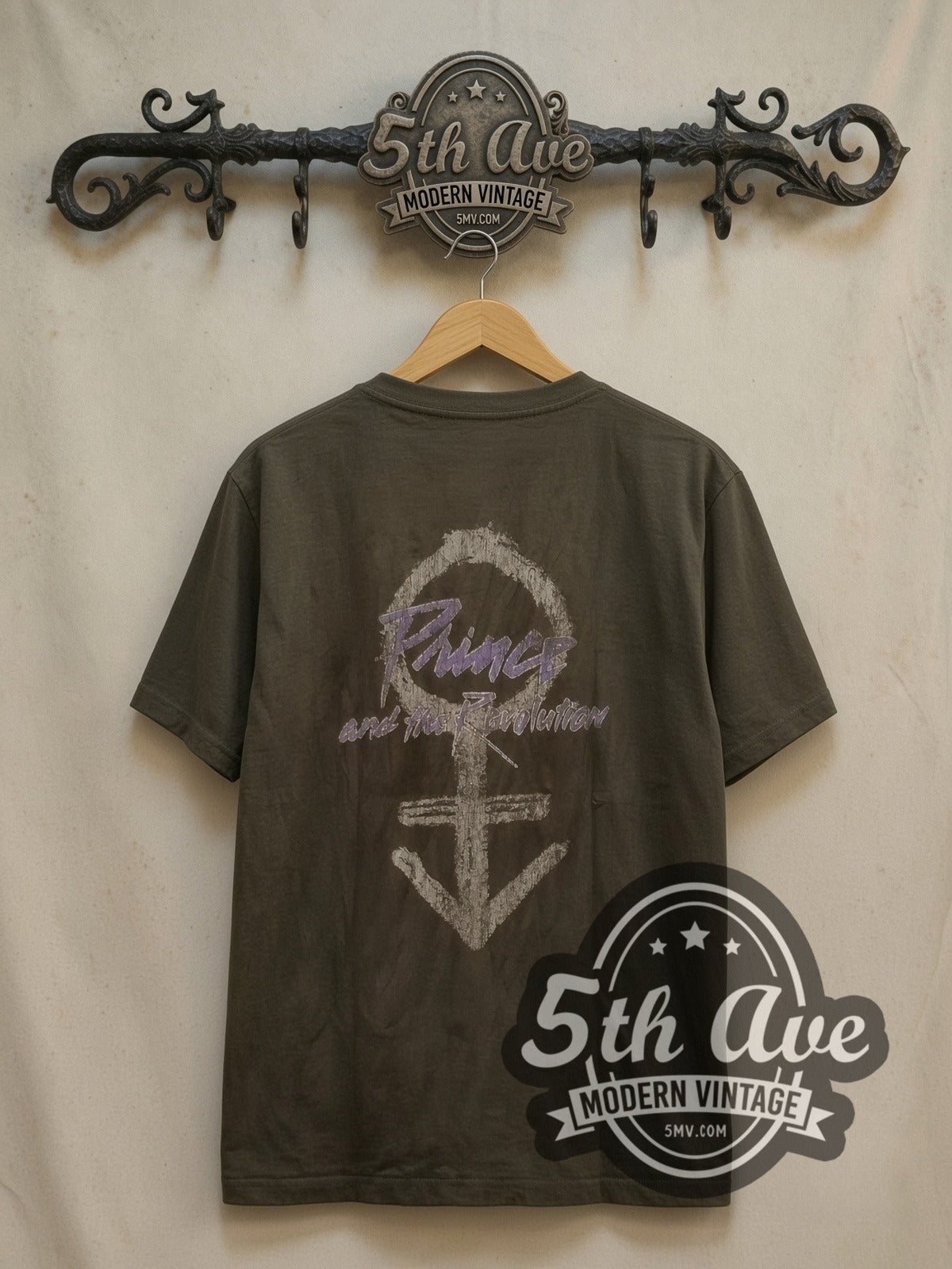 Prince Purple Rain Script Motorcycle vintage band t-shirt, back view on a display rack