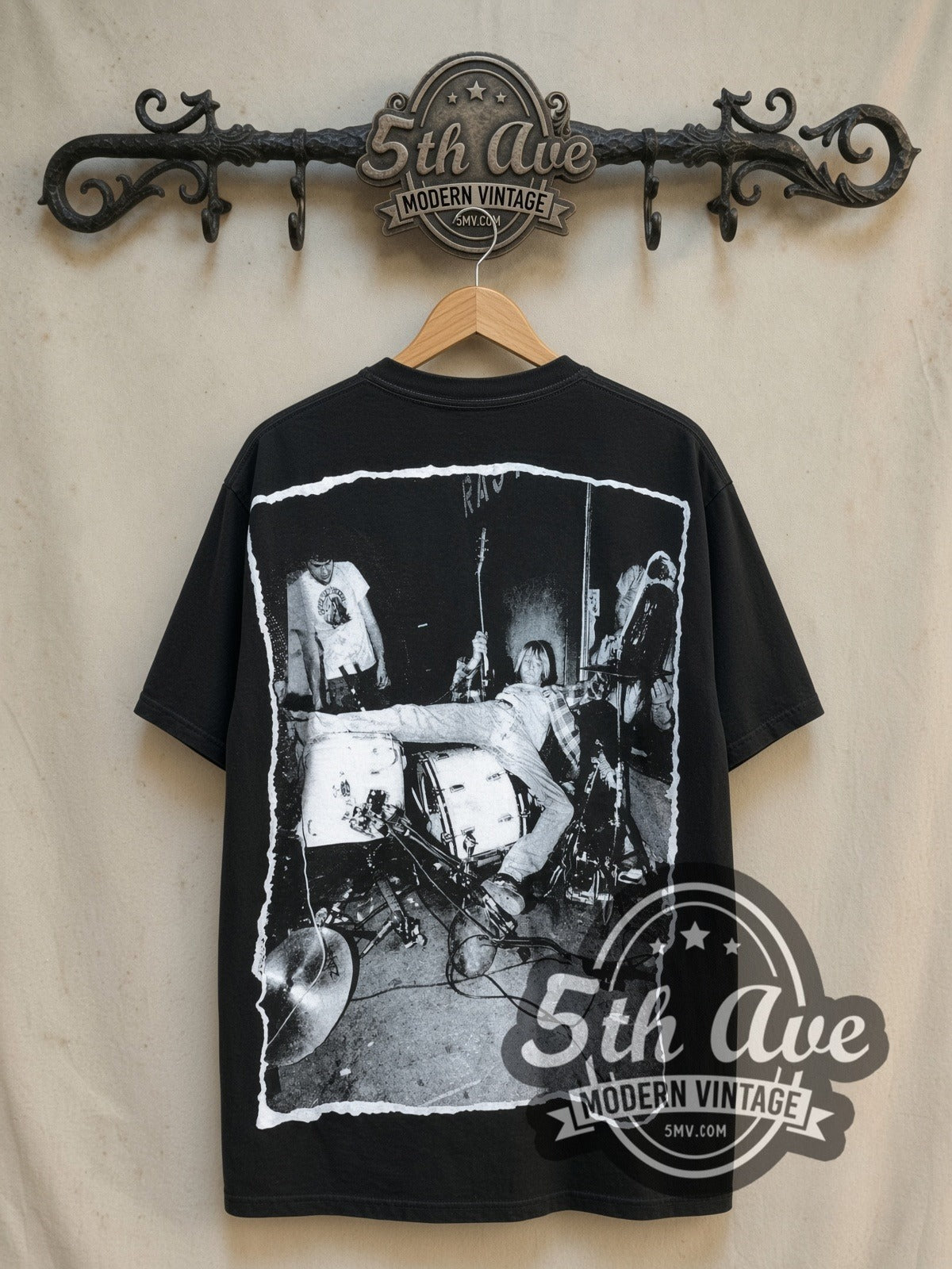 Nirvana Kurt Cobain all-over-print vintage band t-shirt, back view on a display rack