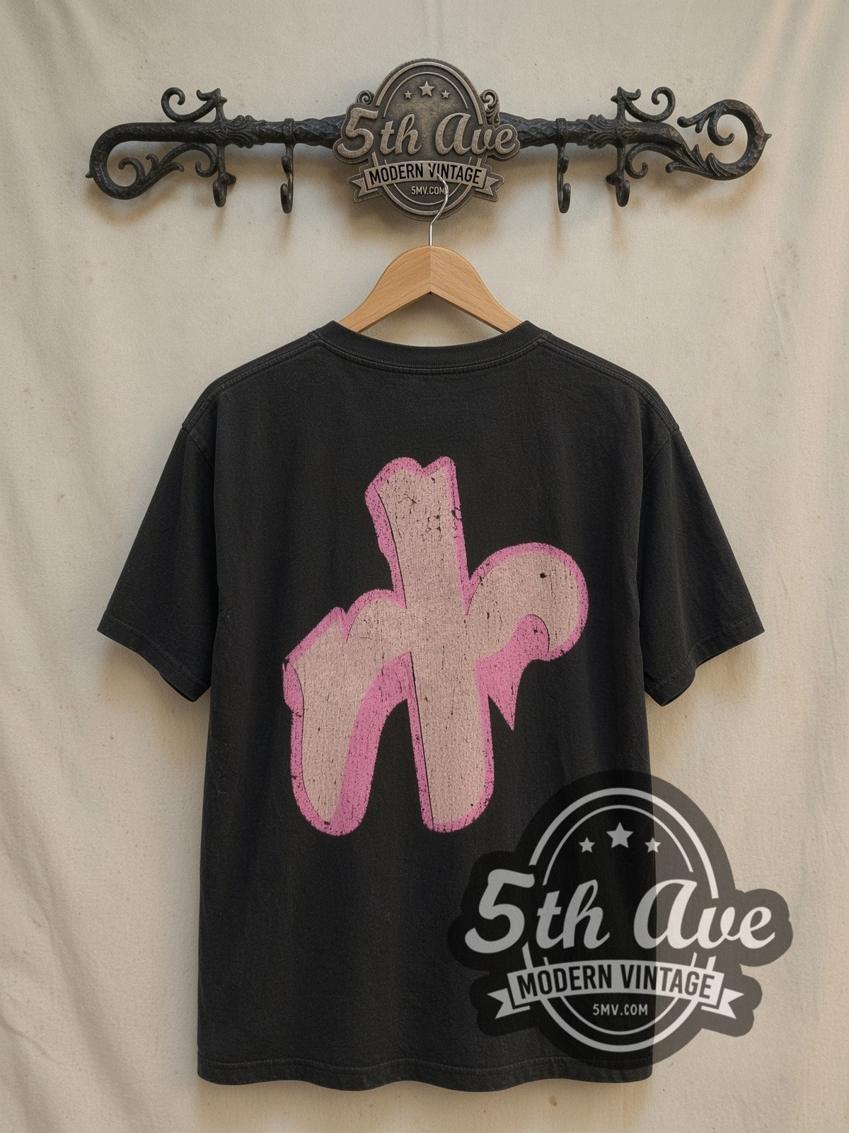 Barbie Pink Heart vintage cartoon tee in black, back view on a display rack