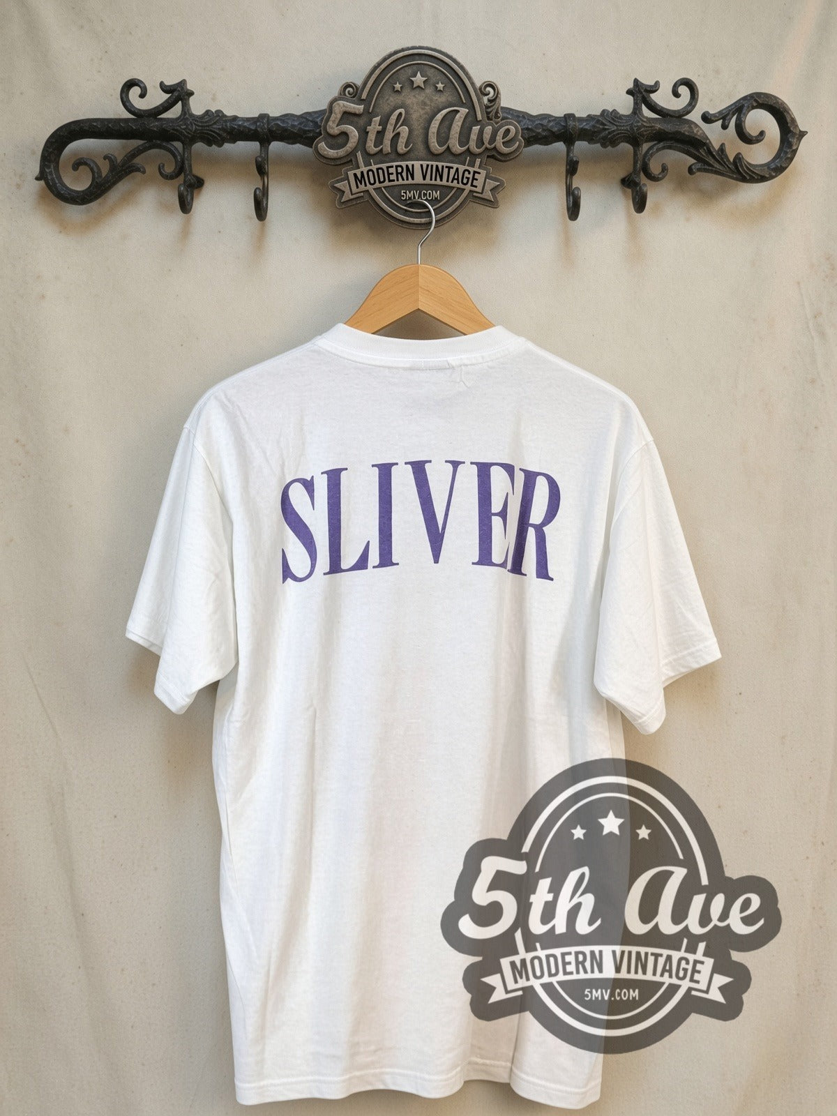 Nirvana Sliver Blue Logo Anatomical Figure White vintage band t-shirt, back view on a display rack