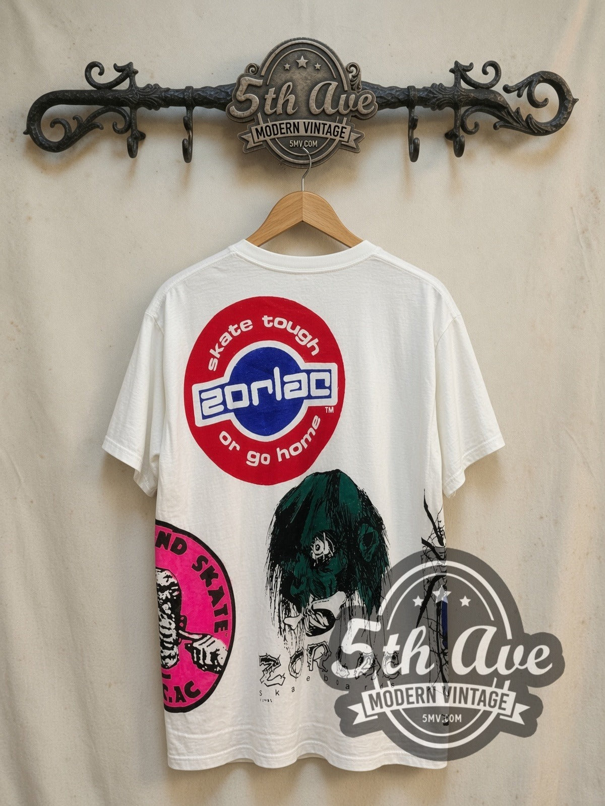 Zorlac Skateboards Shut Up and Skate all-over-print vintage graphic tee, back view on a display rack