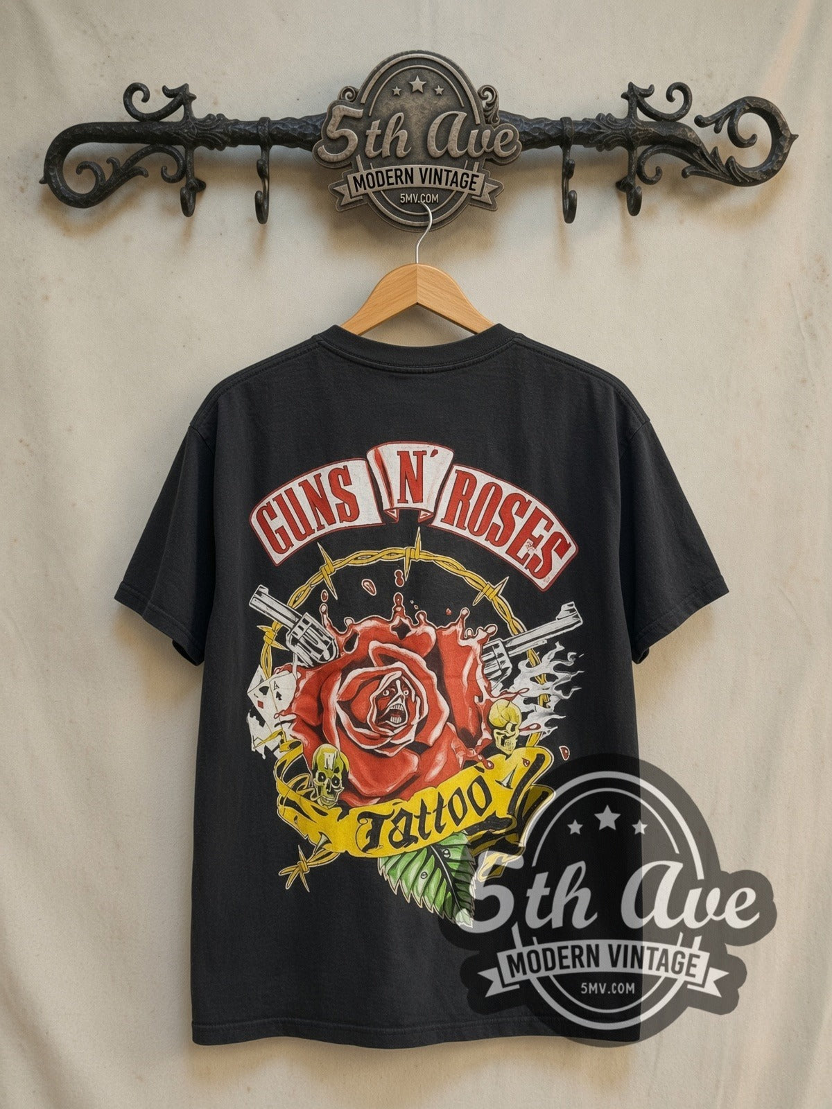 Guns N' Roses Whiskey all-over-print vintage band t-shirt in black, back view on a display rack