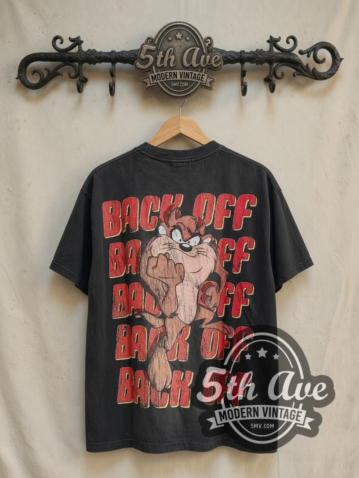 Looney Tunes Taz-Mania Back Off vintage cartoon tee in black, back view on a display rack