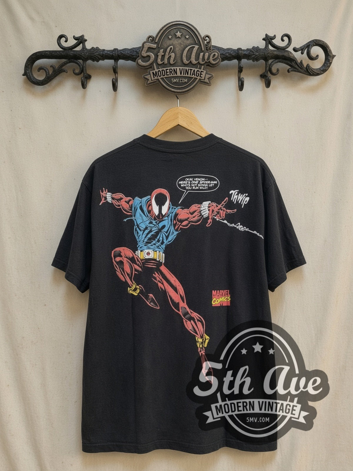 Spider-Man all-over-print graphic tee, back view on a display rack