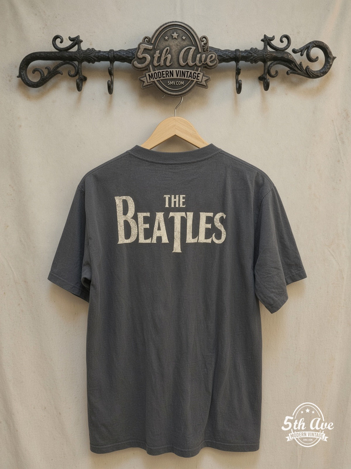 The Beatles – Four Faces Classic Logo – Vintage Band T-Shirt — back on locked cream ornate 5th Ave rack