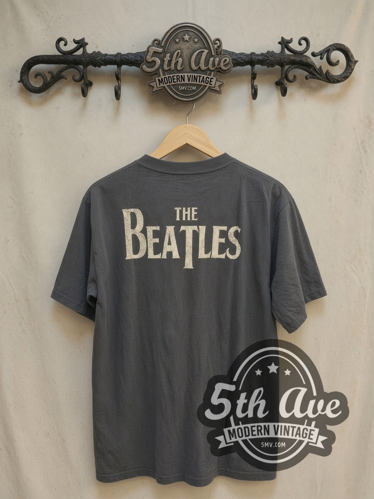 The Beatles Four Faces Classic Logo vintage band t-shirt, back view on a display rack