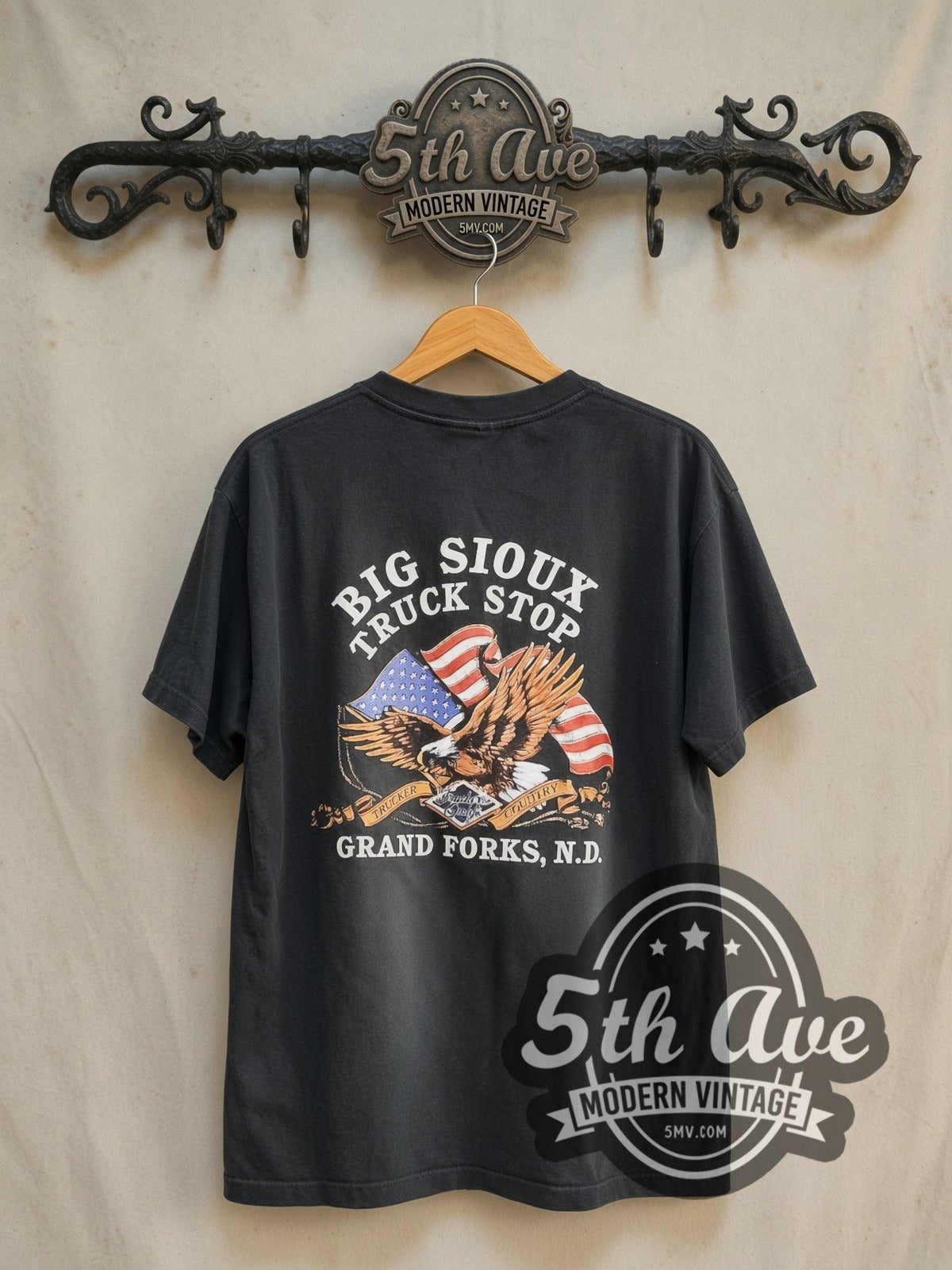 Road Wrangler Truckers Only Big Sioux Truck Stop vintage graphic tee in black, back view on a display rack