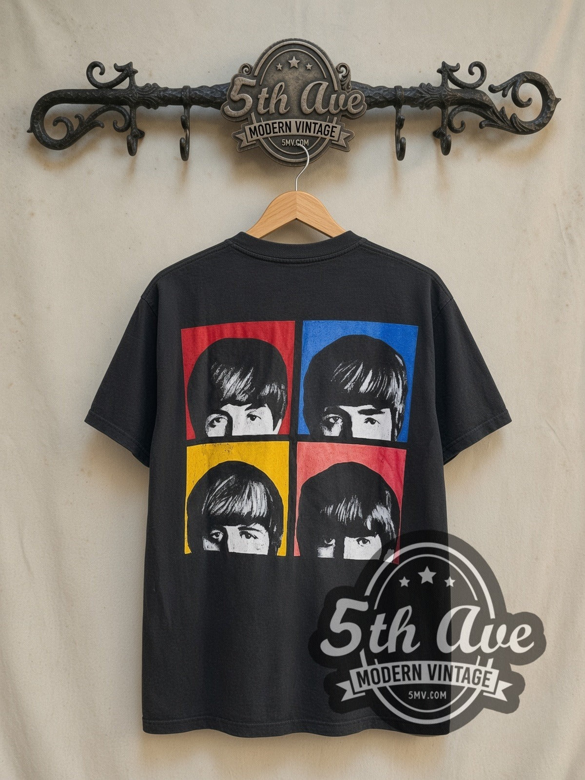 The Beatles Please Please Me 1963 vintage band t-shirt in black, back view on a display rack