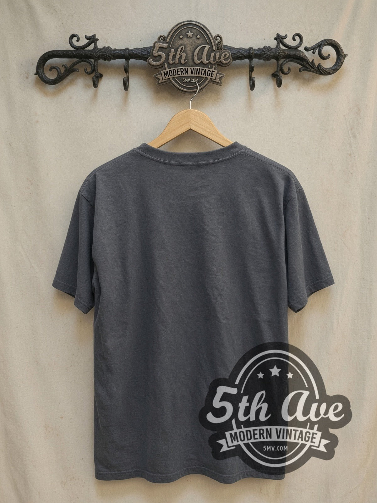 Queen Live at Wembley Stadium vintage band t-shirt, back view on a display rack