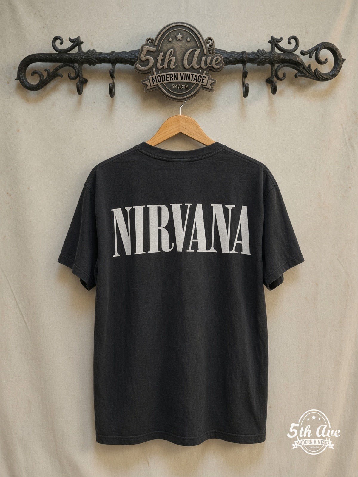 Nirvana – Kurt Cobain 1967-1994 – Vintage Band T-Shirt — back on locked cream ornate 5th Ave rack