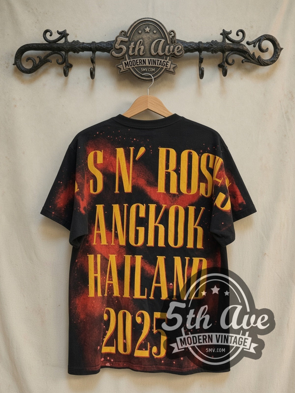 Guns N' Roses Bangkok World Tour 2025 all-over-print vintage band t-shirt, back view on a display rack